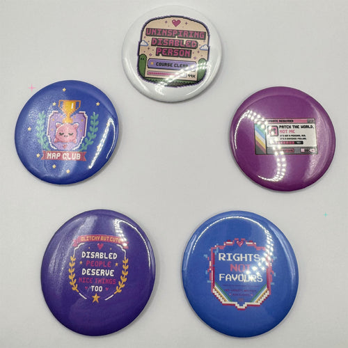 Five large 58mm disability and chronic illness themed button badges from Glitchy But Cute