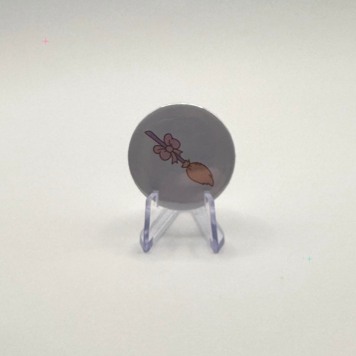 32mm pastel broom badge on a white background