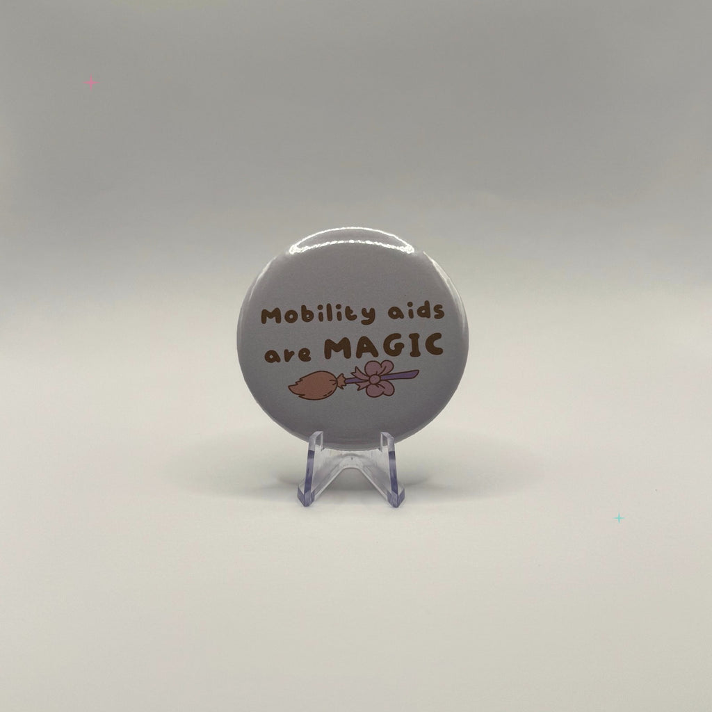 58mm Mobility aids are MAGIC slogan badge on a white background