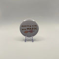 58mm Mobility aids are MAGIC slogan badge on a white background