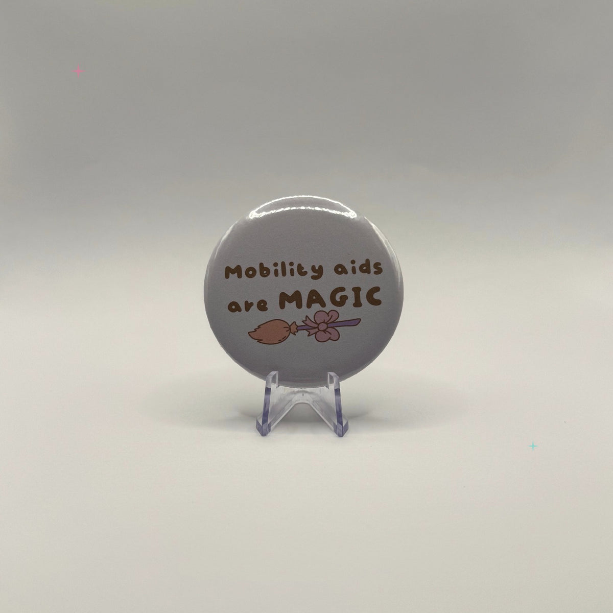 58mm Mobility aids are MAGIC slogan badge on a white background