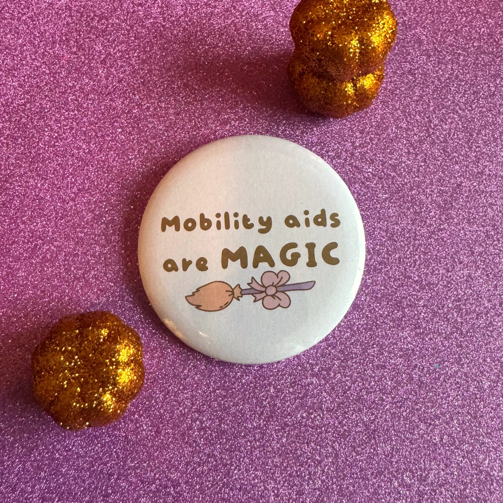 Mobility aids are MAGIC slogan badge on a glittery pink background