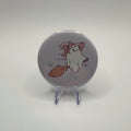 58mm witchy ghost on broom badge on a white background