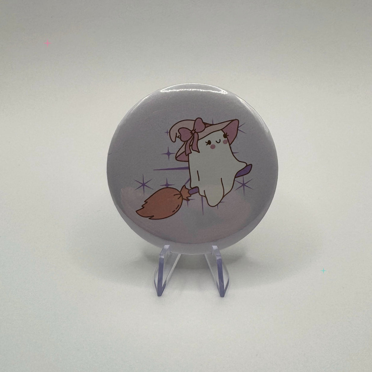 58mm witchy ghost on broom badge on a white background