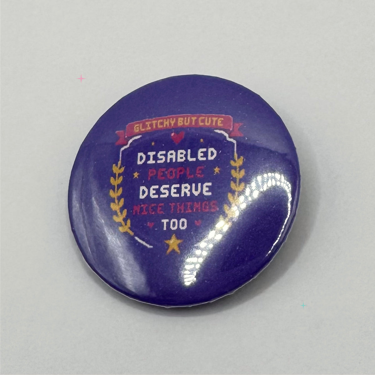 Purple 32 mm pin badge reading Disabled People Deserve Nice Things Too