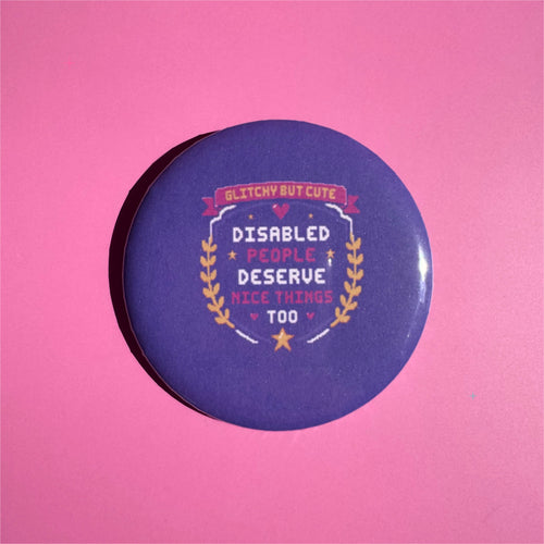 58mm purple Disabled People Deserve Nice Things Too button badge on a pink background