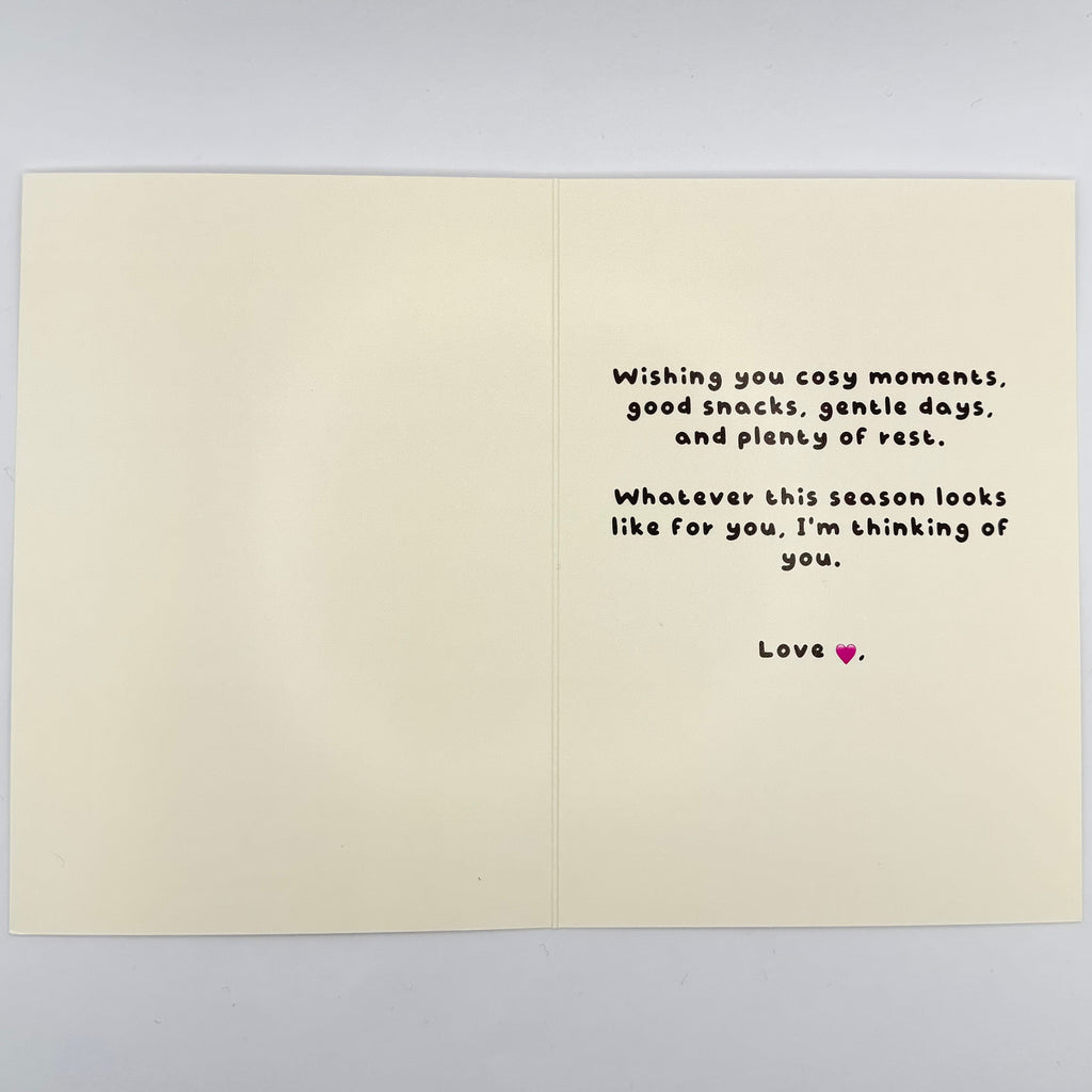 Open cream Christmas card showing the shared printed message about cosy moments, gentle days and rest.