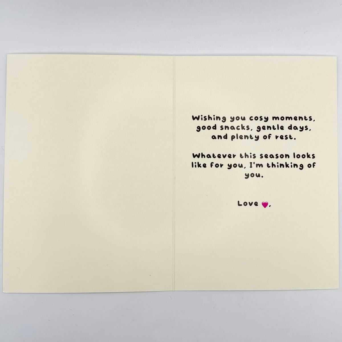 Open cream Christmas card showing the shared printed message about cosy moments, gentle days and rest.