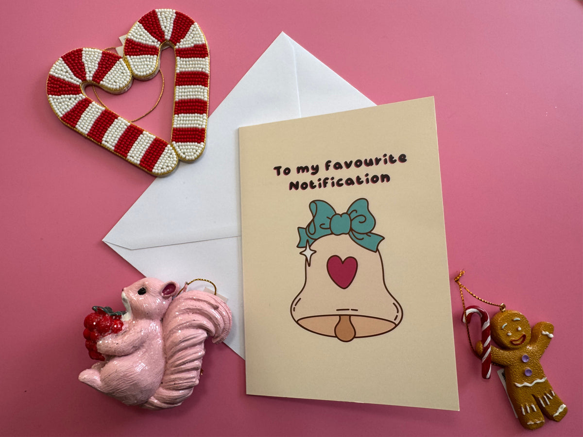 To My Favourite Notification Christmas card and envelope styled on pink paper with festive decorations.