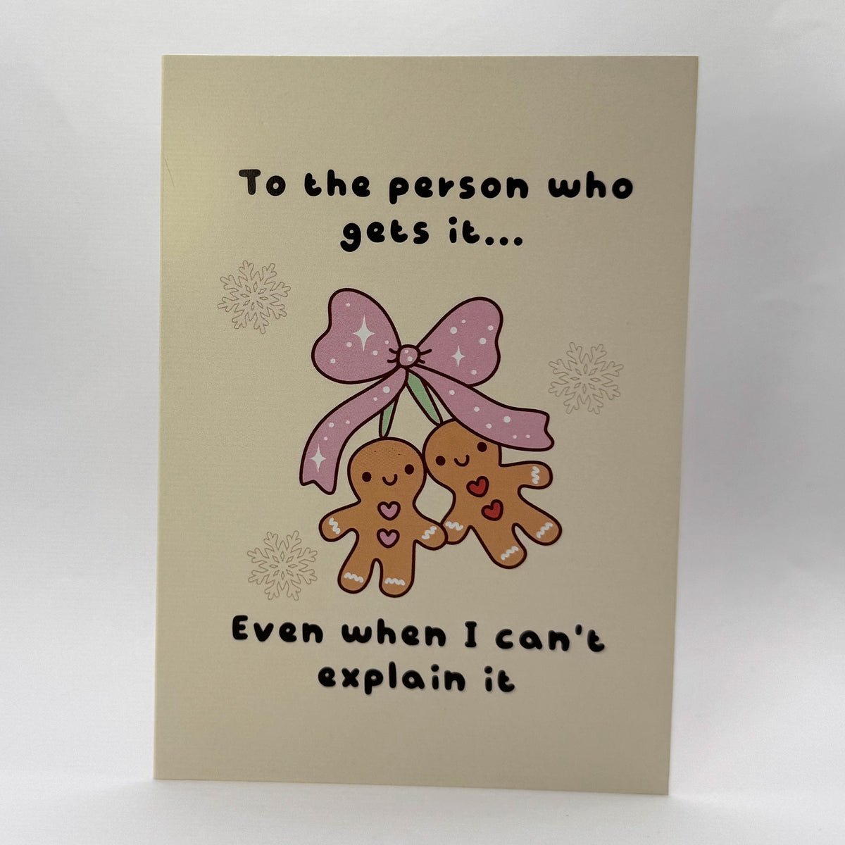To the Person Who Gets It A6 Christmas card with an illustration of two gingerbread characters.