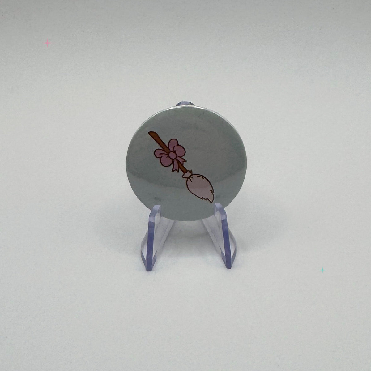 Hexecutive Dysfunction broom with bow 32mm badge on white background