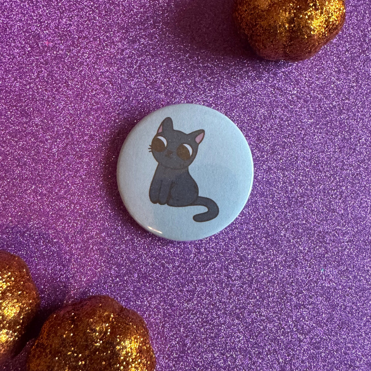 Hexecutive Dysfunction black cat 32mm badge on glittery pink background