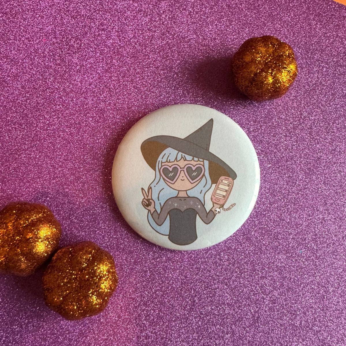 Hexecutive Dysfunction witch 58mm badge on glittery pink background