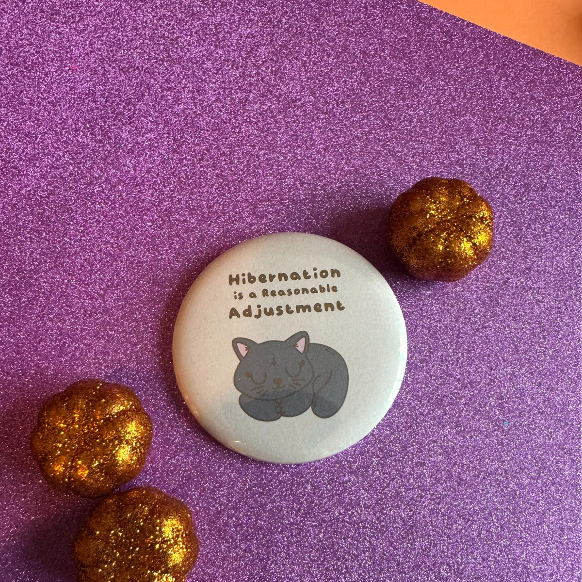 Hibernation Is a Reasonable Adjustment Black Cat 58mm badge lifestyle photo