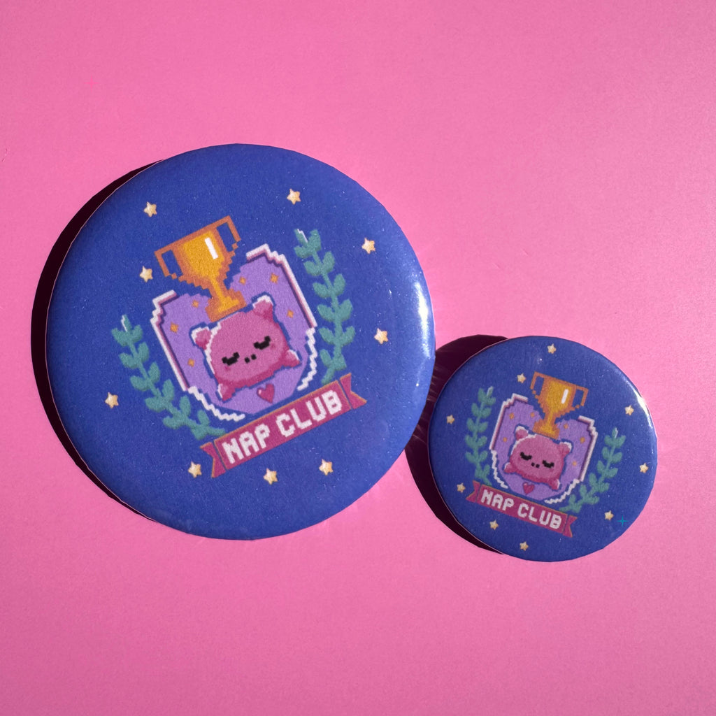 32mm and 58mm blue Nap Club button badges on a pink background
