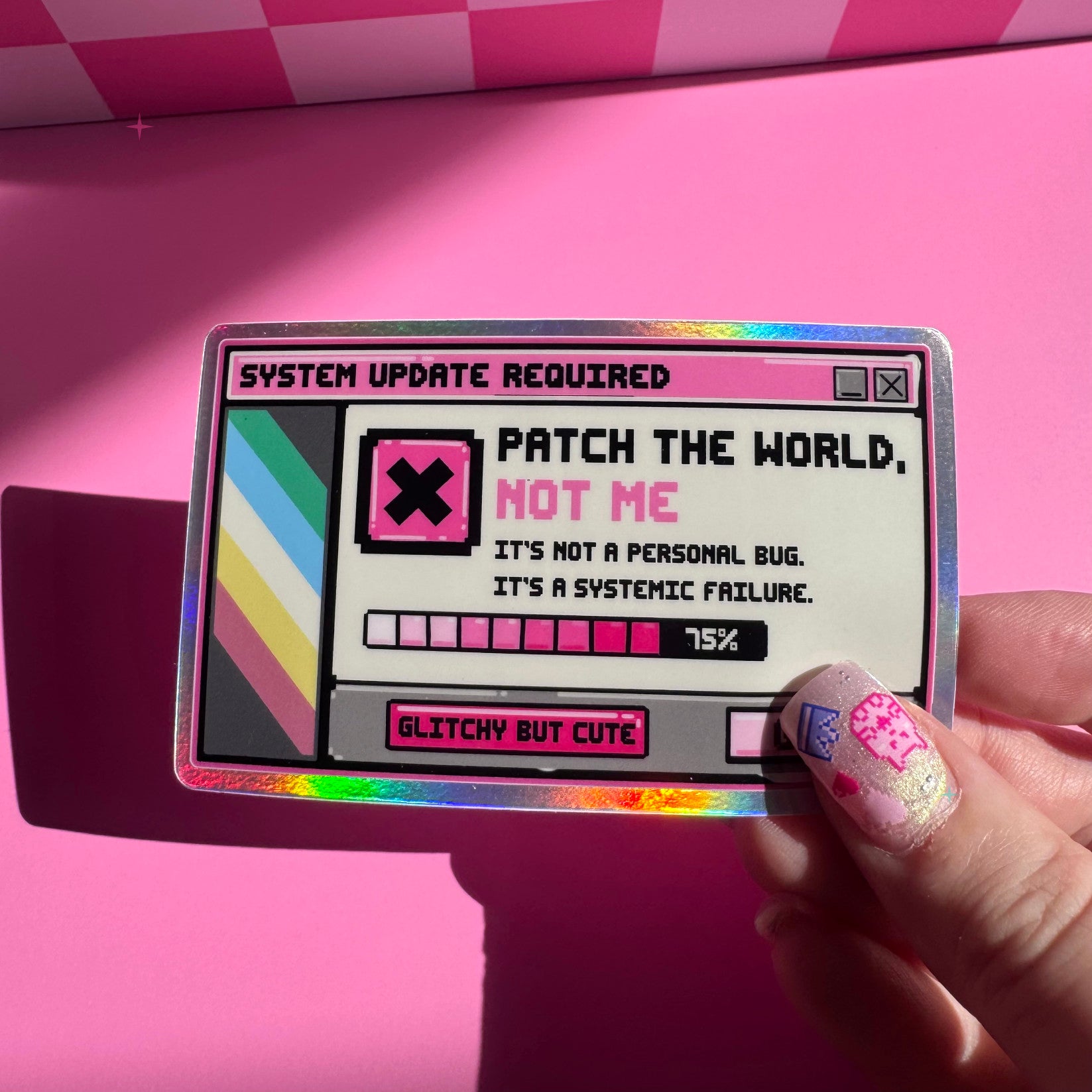 Patch the World, Not Me holographic sticker held between fingers to show its size and rainbow shine