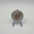 32mm pumpkin spice drink badge on a white background