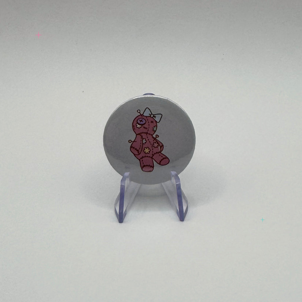 32mm pink voodoo doll badge on a white background