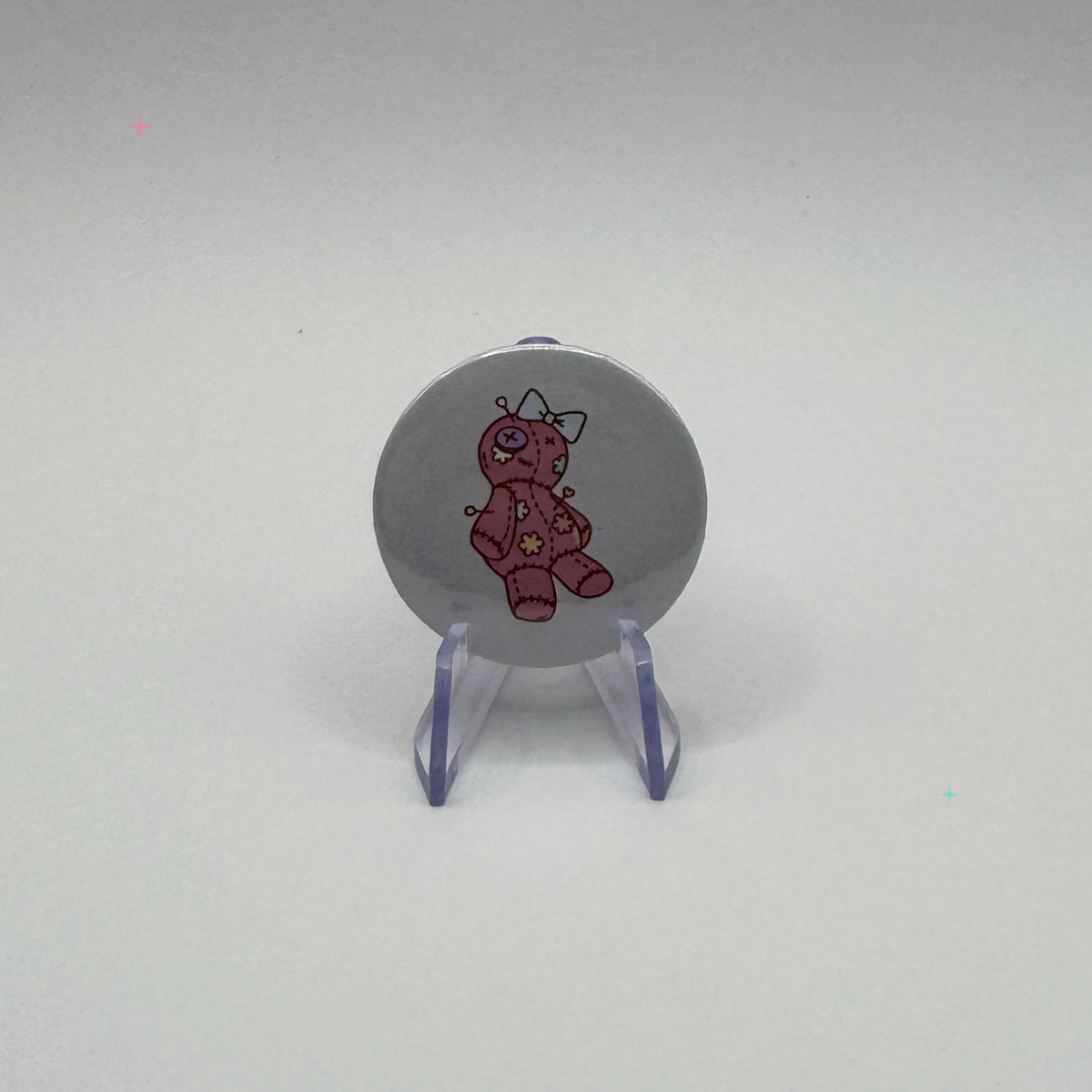 32mm pink voodoo doll badge on a white background