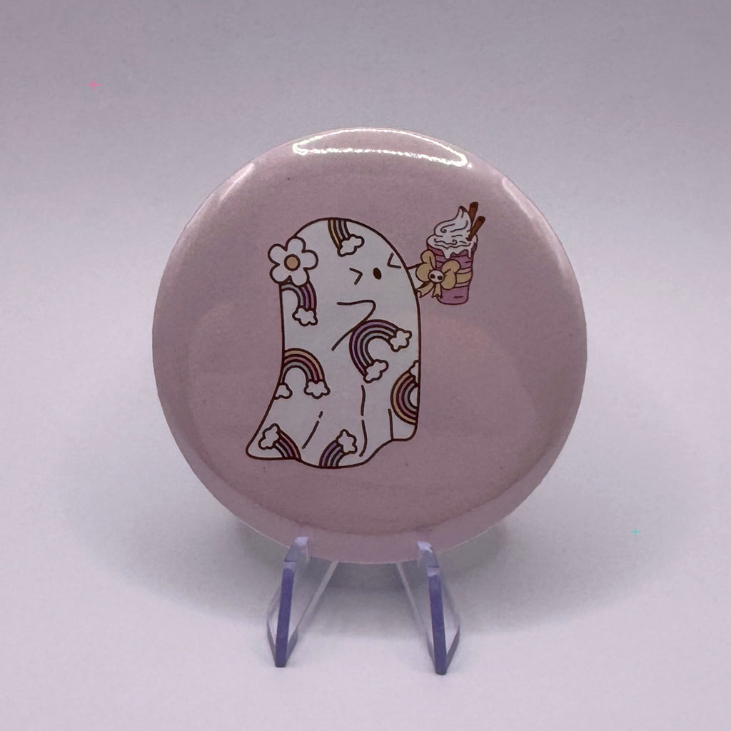58mm ghost holding a pumpkin spice drink badge on a white background