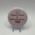 58mm Pumpkin Spice and Symptom Spikes slogan badge on a white background