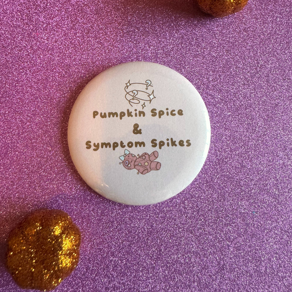 Pumpkin Spice and Symptom Spikes slogan badge on a glittery pink background