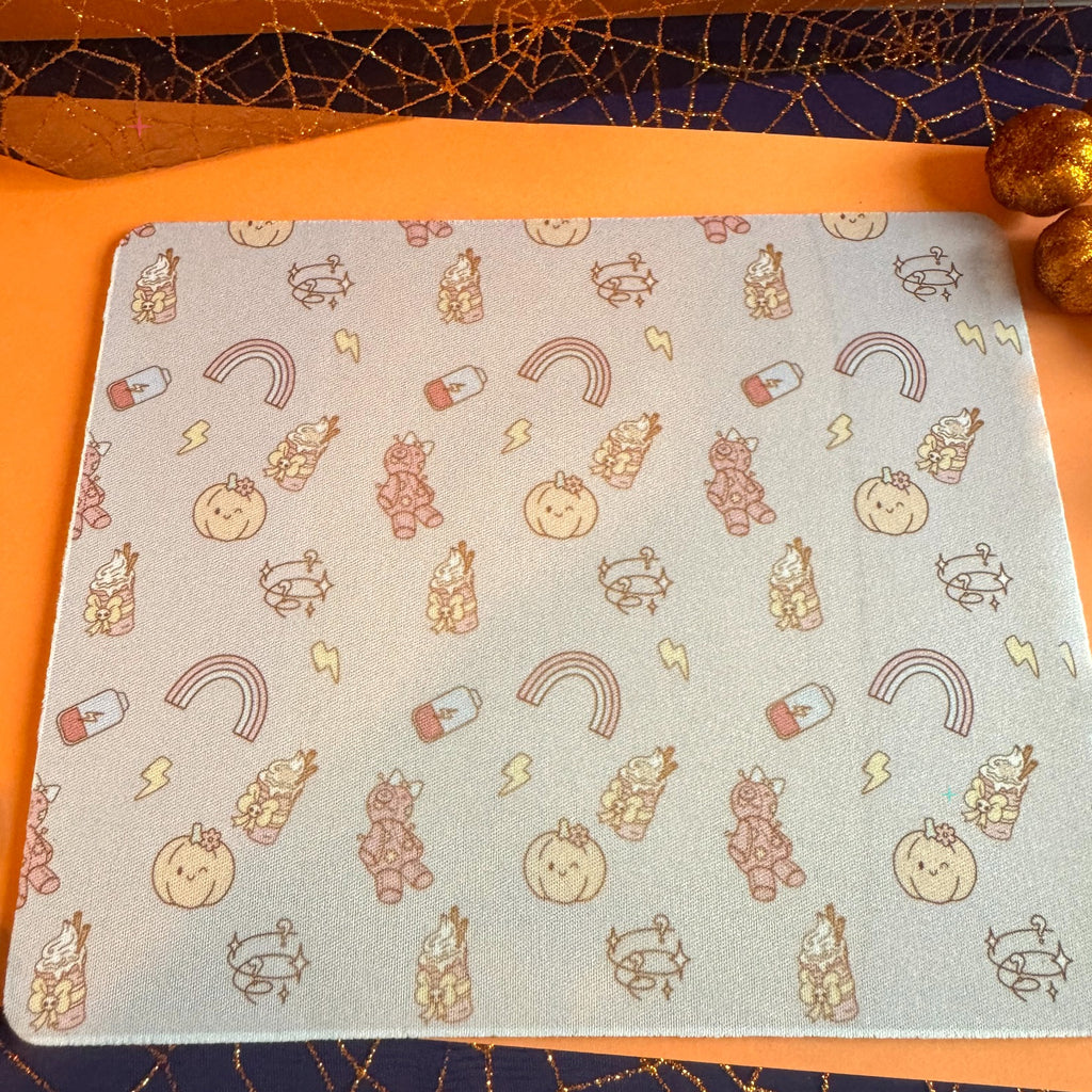 Pumpkin Spice and Symptom Spikes patterned mousemat styled with autumn props