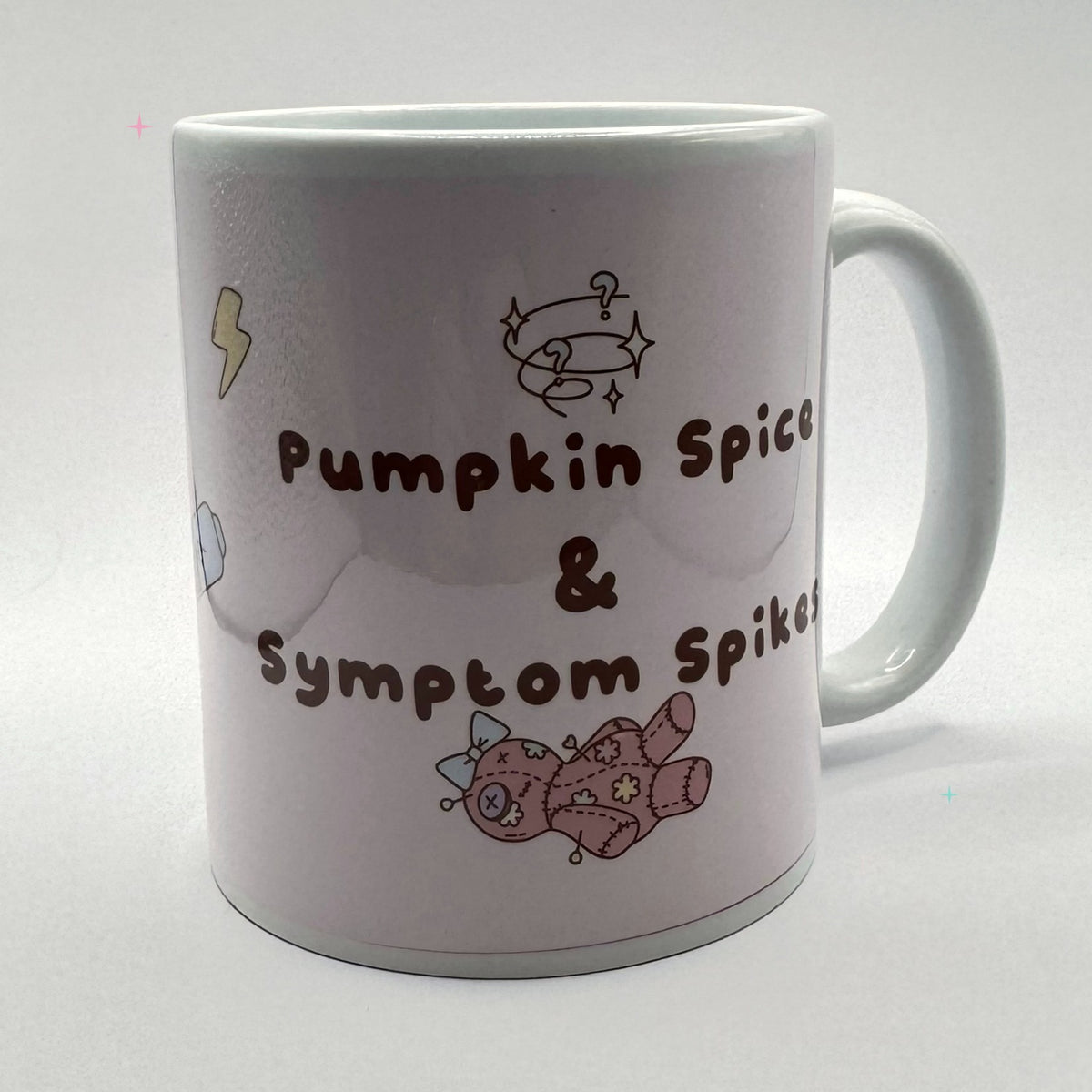 11oz Pumpkin Spice and Symptom Spikes mug showing the slogan artwork