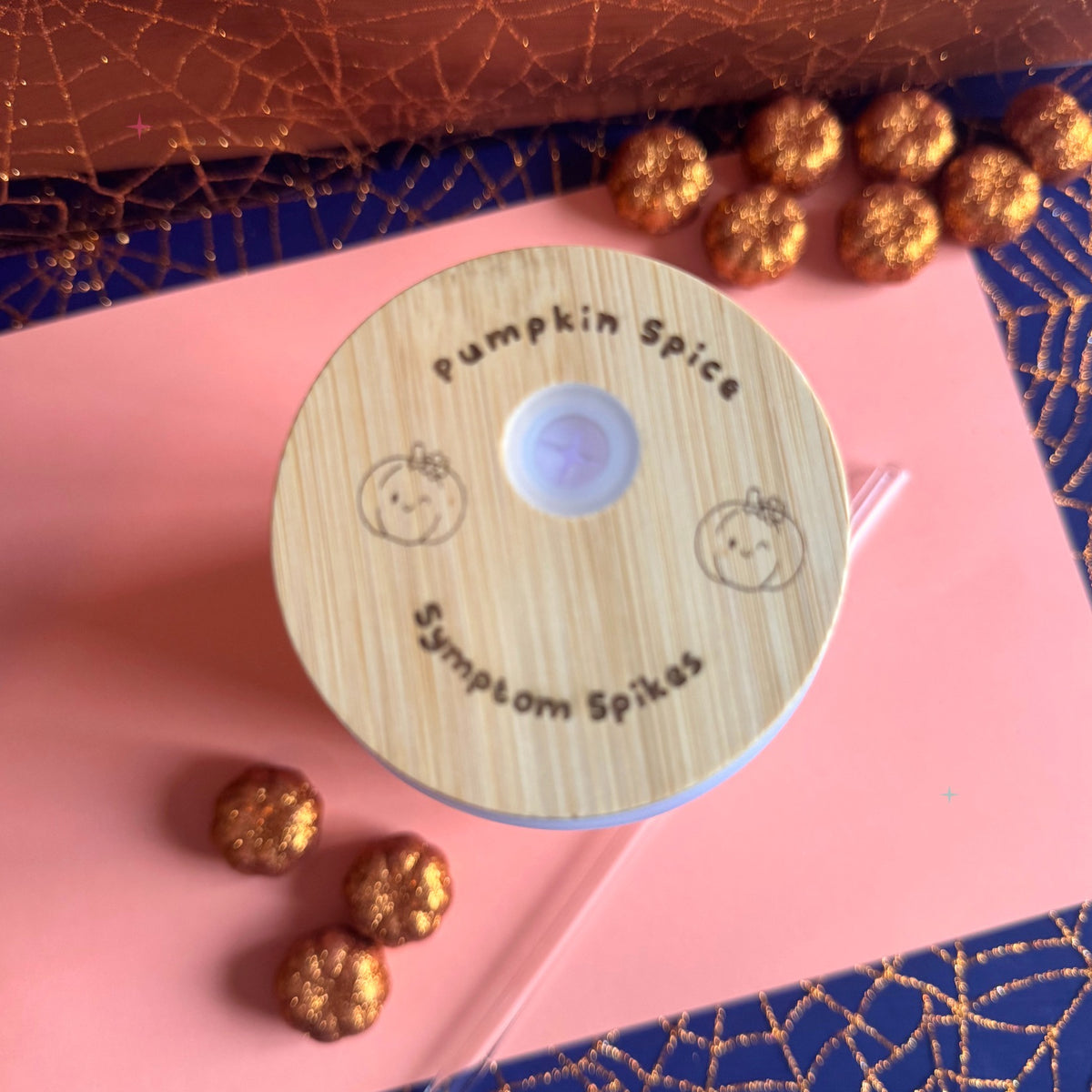 Engraved bamboo tumbler lid styled with autumn props