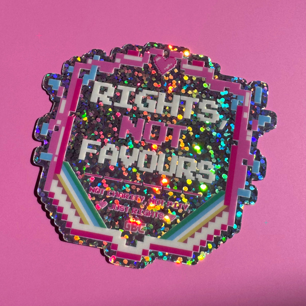 Rights, Not Favours glitter holographic sticker on a pink background